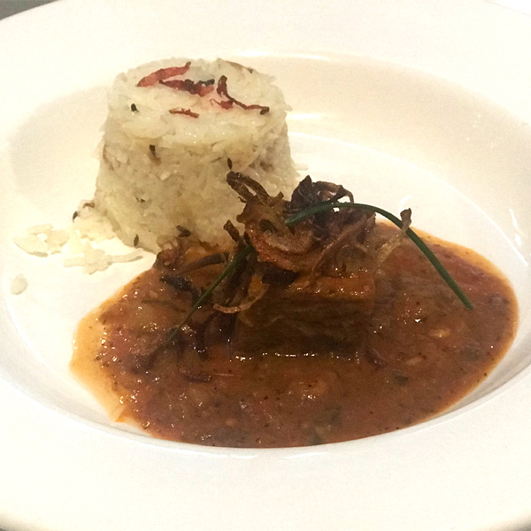 Indian restaurant meal consisting of beef and rice